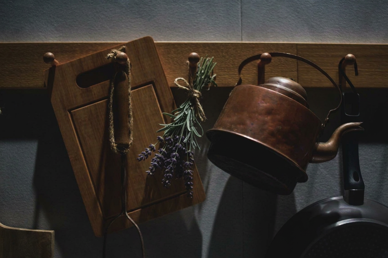 rustic copper kettle and cutting board in kitchen